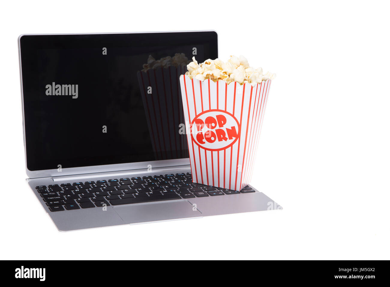 Open laptop with a tub of popcorn isolated on white Stock Photo - Alamy