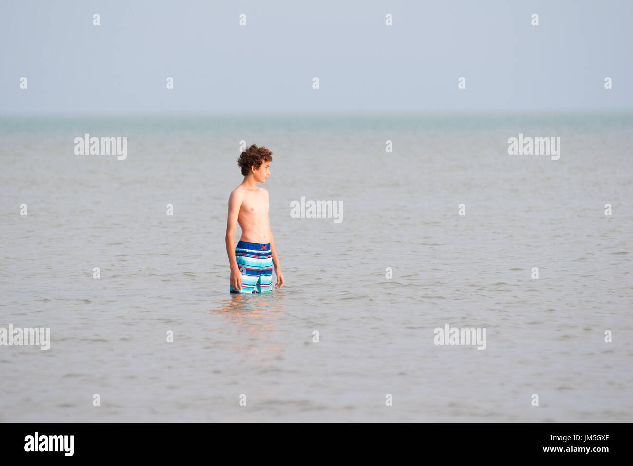 Thirteen year old boy in the water of Lake Erie Stock Photo