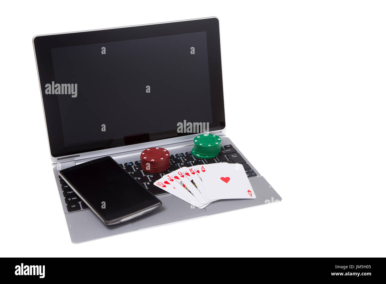 open laptop and smart phone with poker chips and a winning royal flush