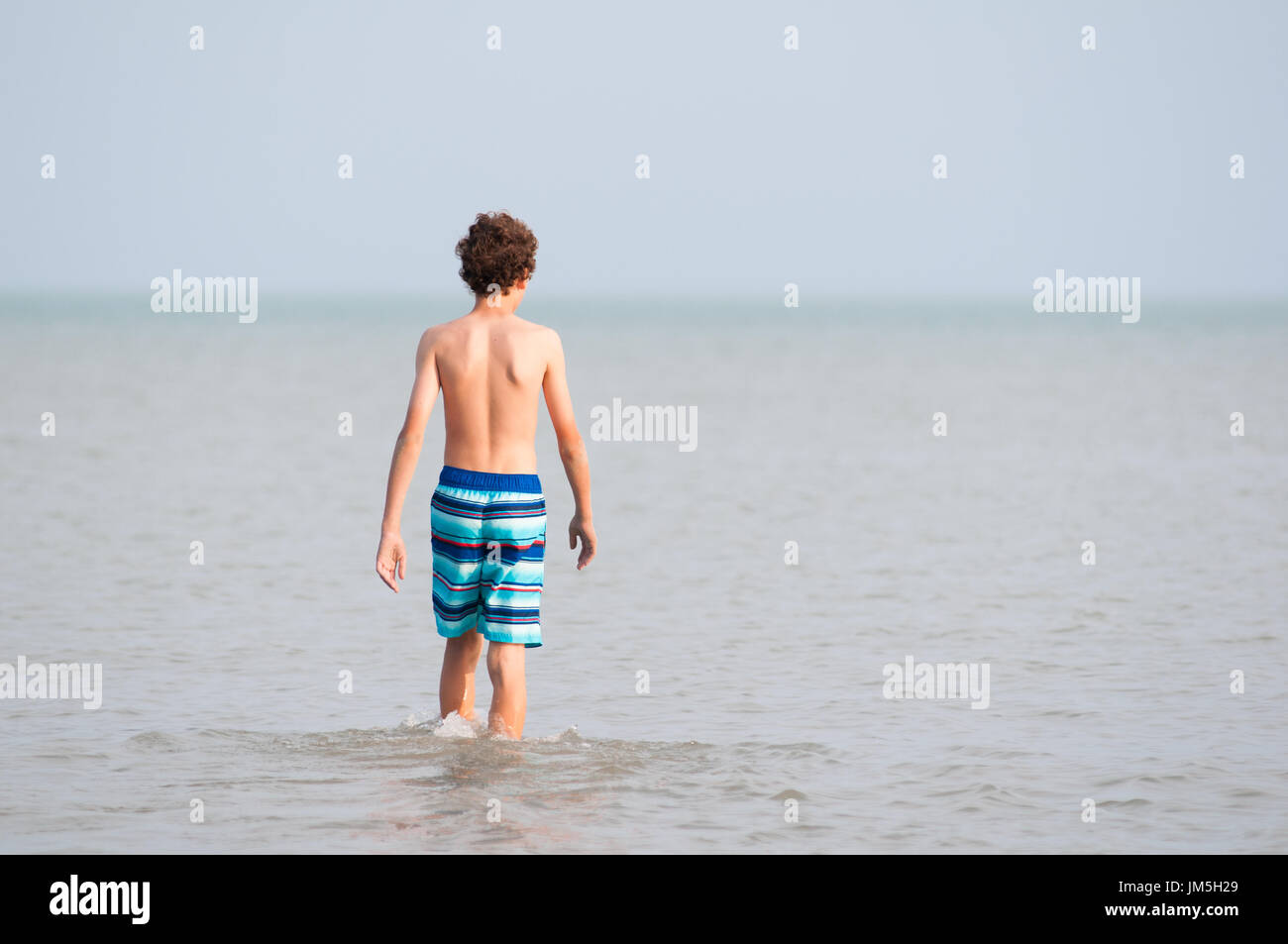 Thirteen year old boy in the water of Lake Erie Stock Photo Alamy