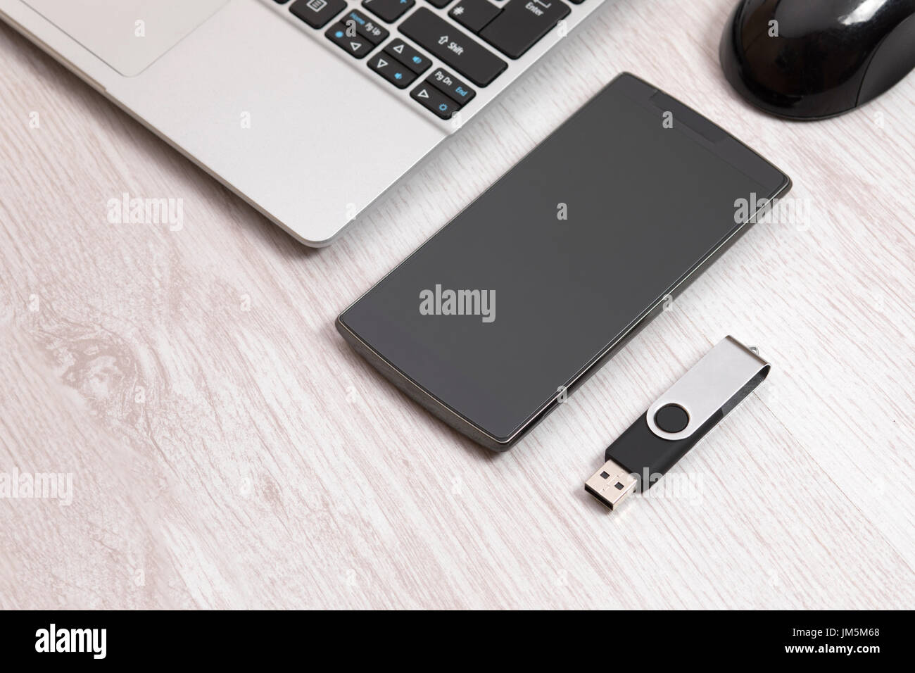 elevated view USB storage back up device on wooden surface with Laptop and smart phone Stock Photo