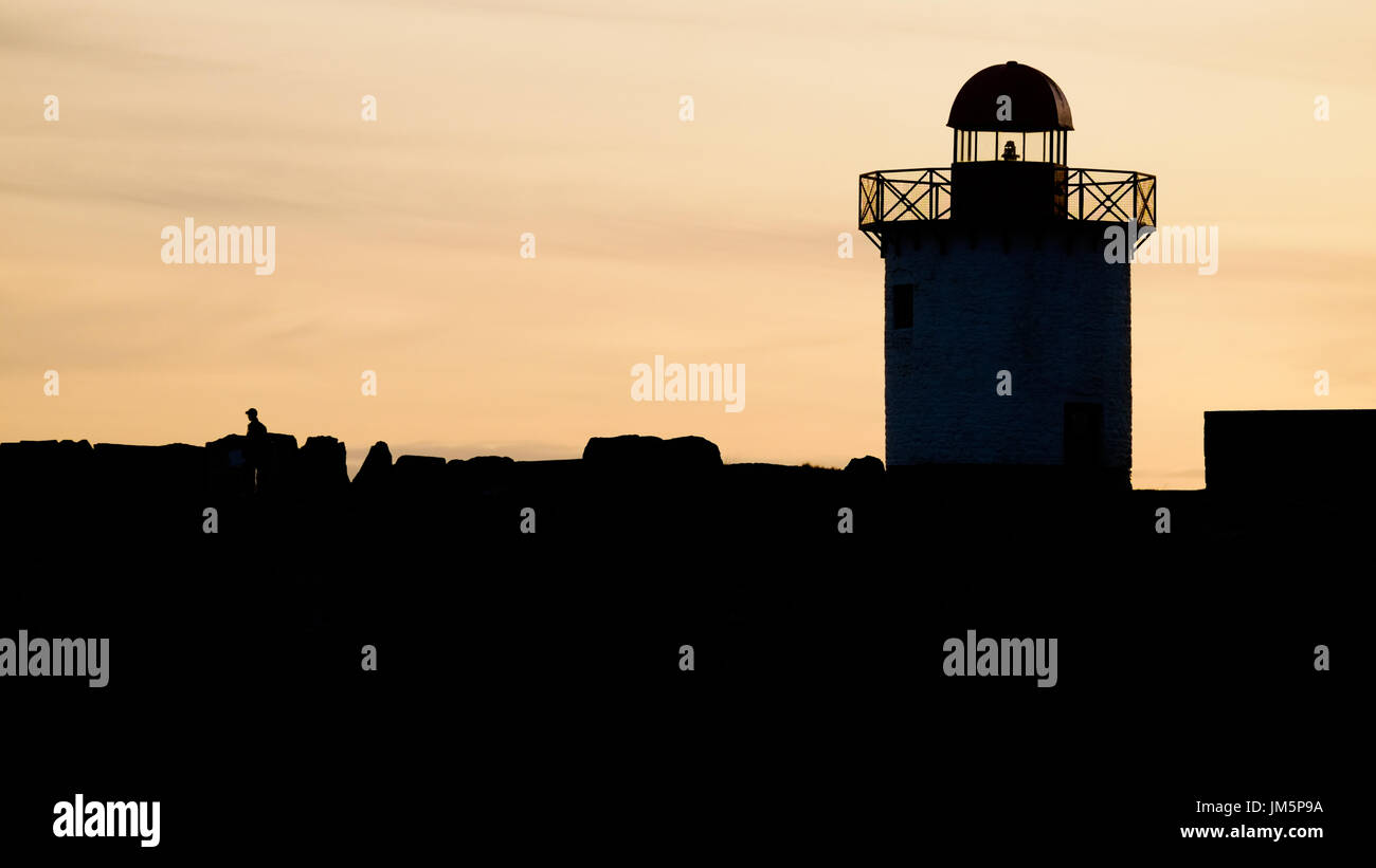 Burry Port lighthouse in silhouette. Carmarthenshire. Wales. UK. Stock Photo