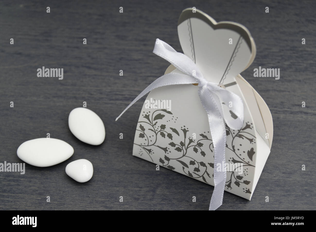 wedding dress shaped box with almond confetti inside Stock Photo Alamy