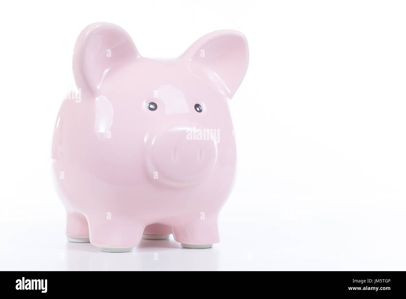 Cute pink ceramic piggy bank on white with copy space for your ...