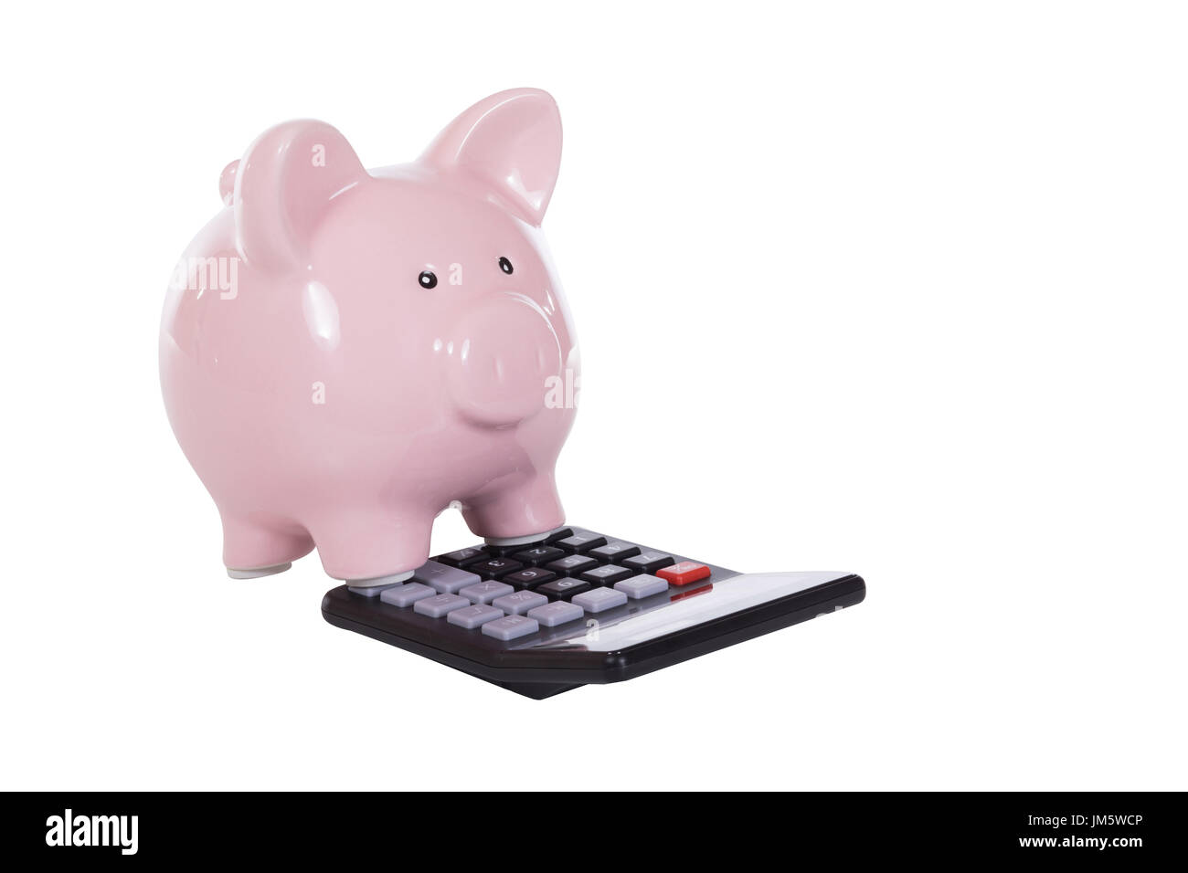 Pink piggy bank standing on a calculator in a financial, investment or ...