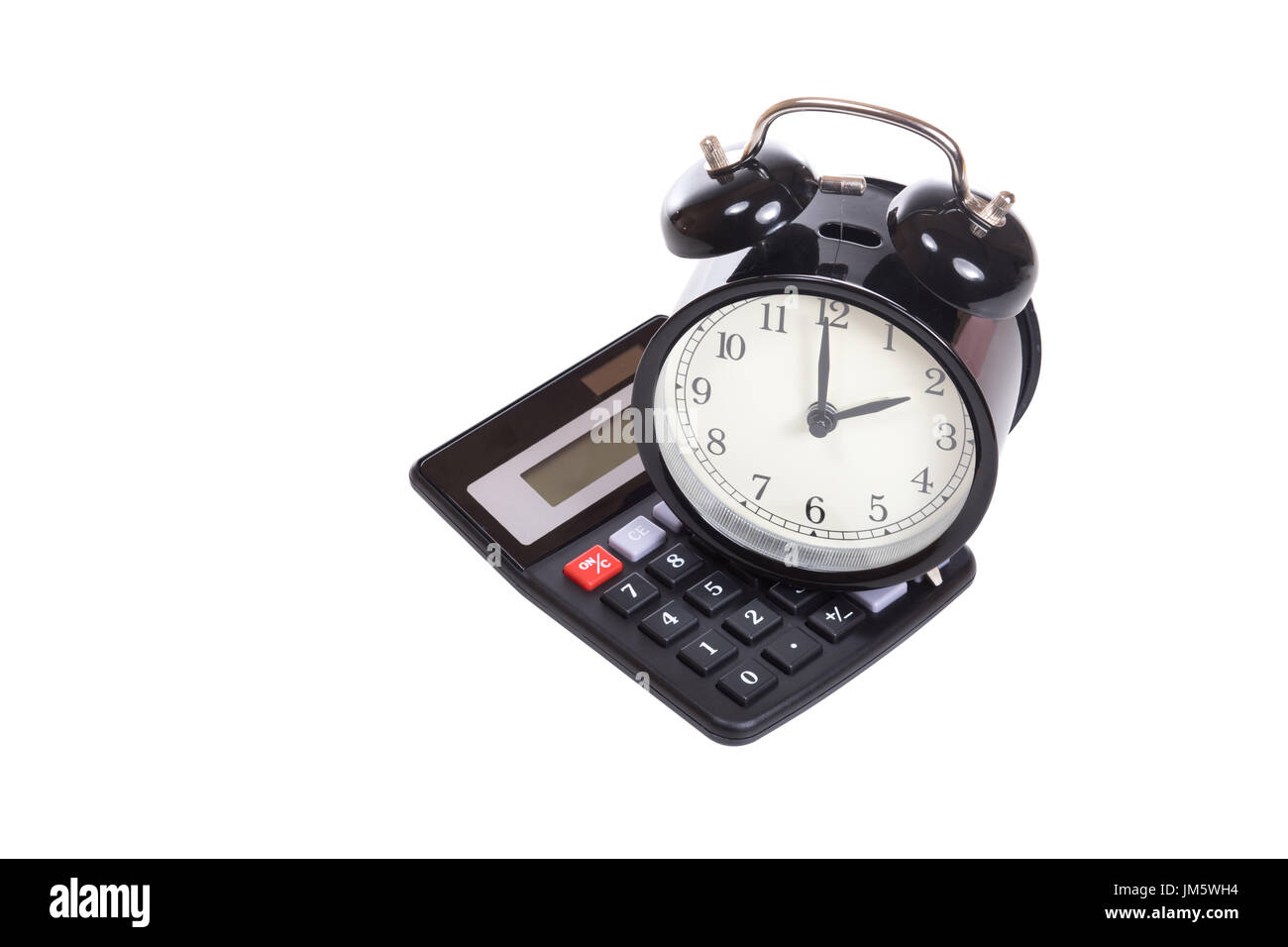 Retro alarm clock on top of a calculator in a conceptual image isolated