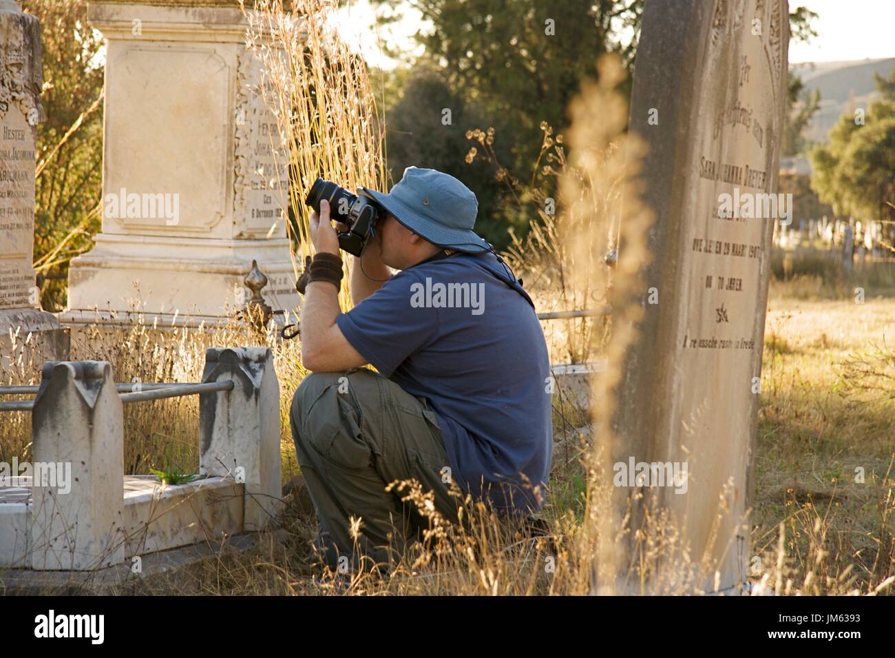 Photographer at work in graveyard Stock Photo