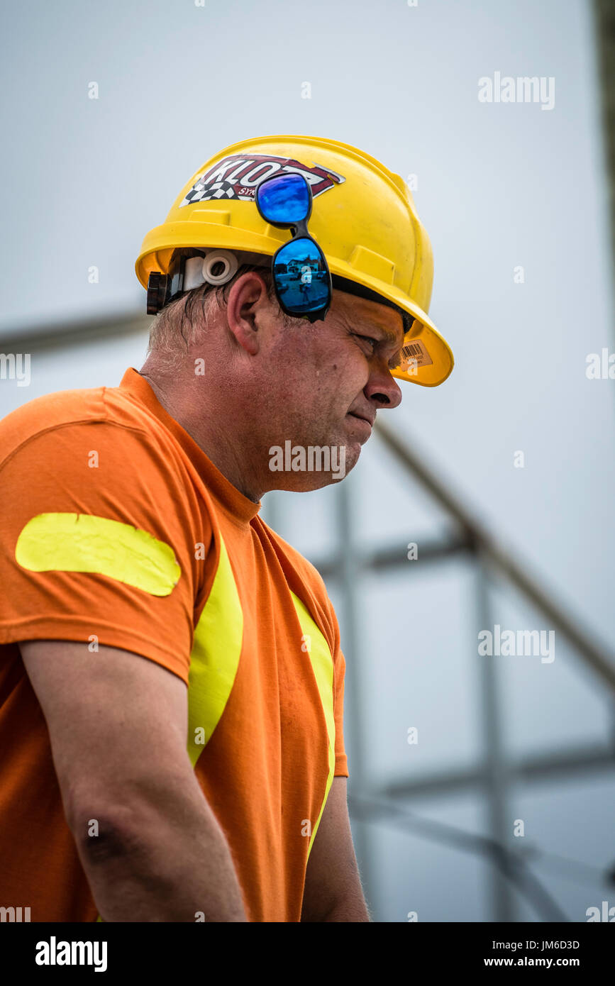 Canadian industrial construction workers laying paving on streets in ...