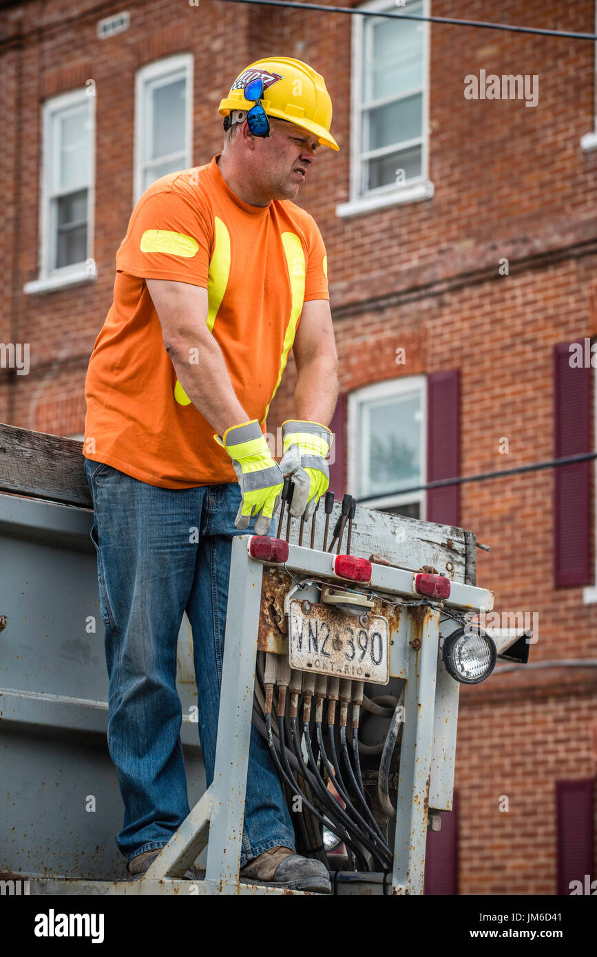 Canadian industrial construction workers laying paving on streets in ...