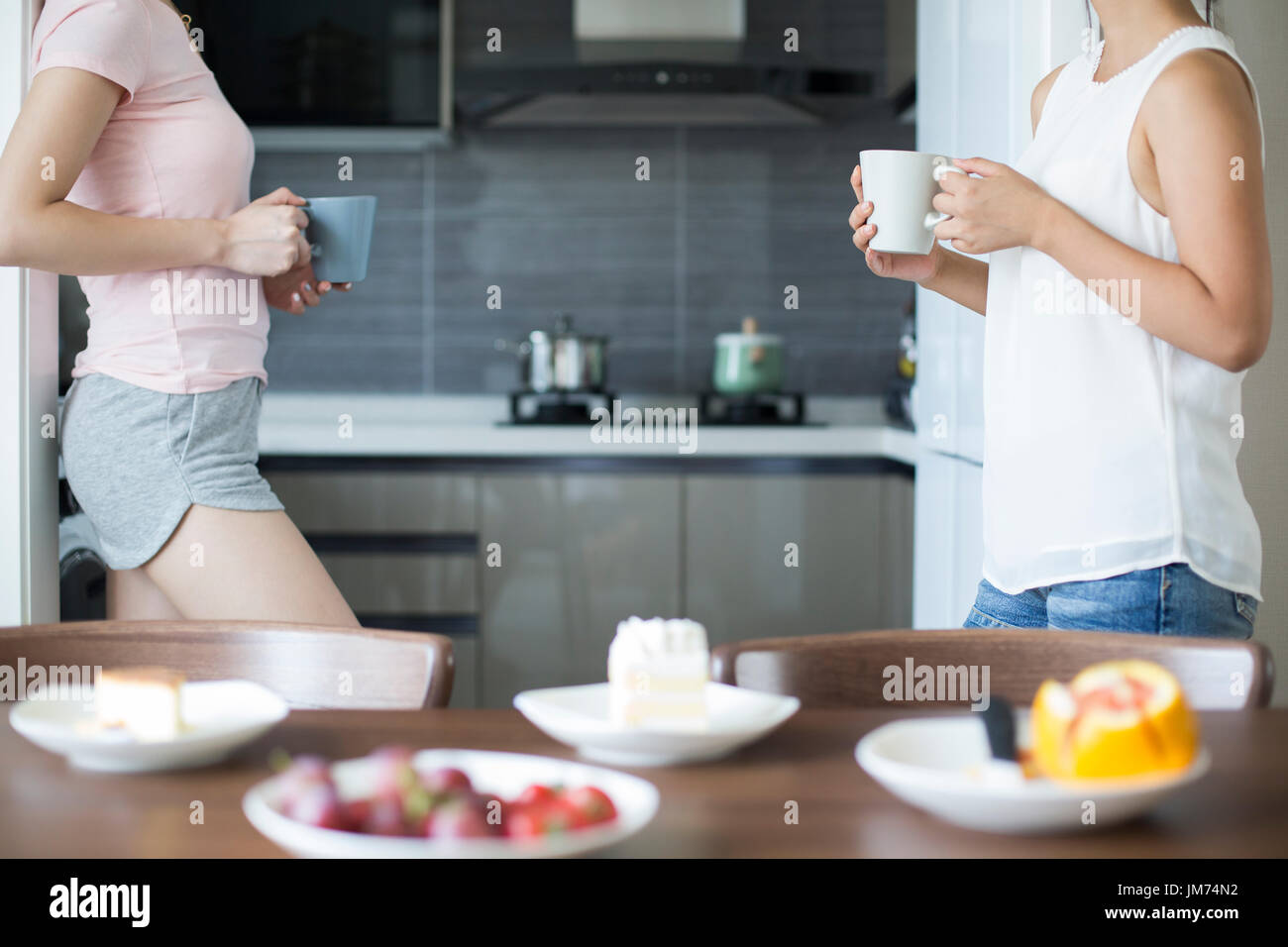 Best female friends having afternoon tea at home Stock Photo