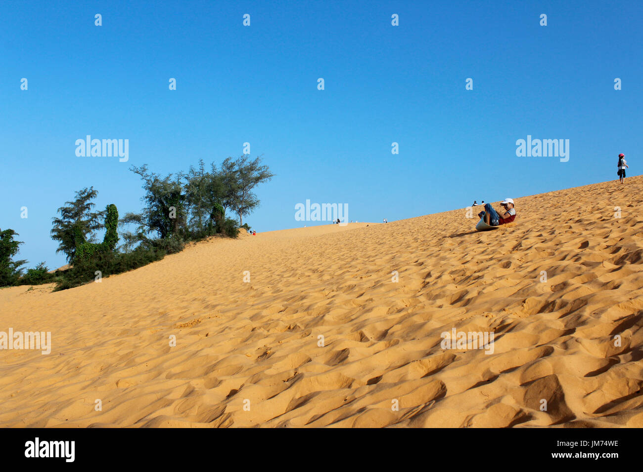 Go sandboarding on the red dunes of Mui Ne