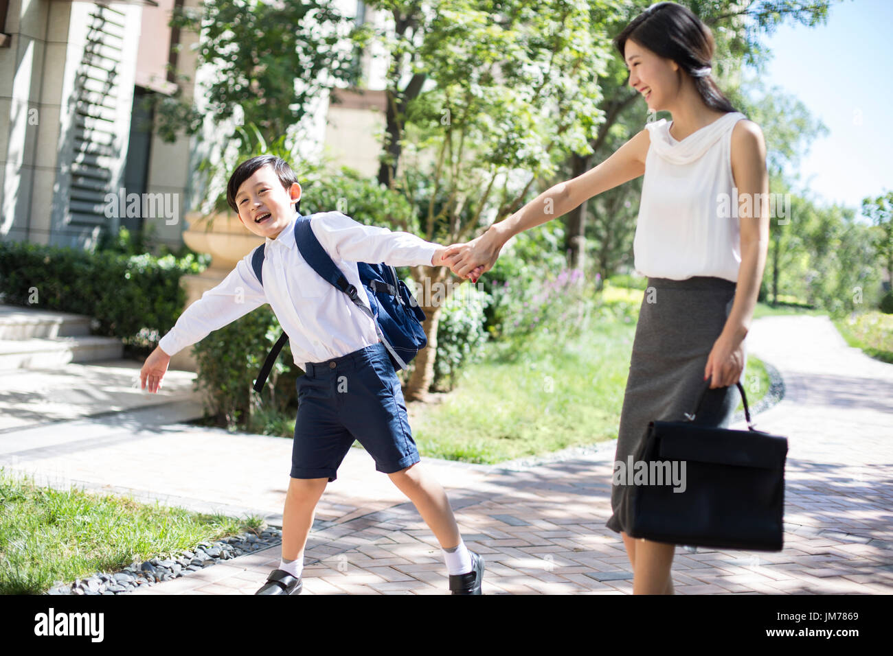 Chinese mother taking her child to school in the morning Stock Photo