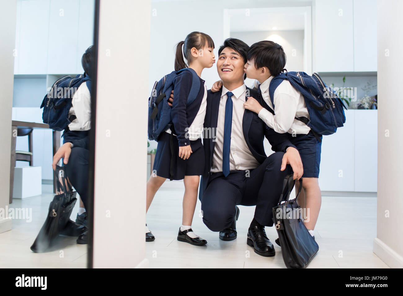 Little Chinese children kissing their father Stock Photo