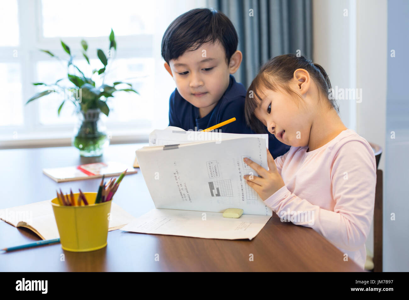 Happy Chinese siblings studying together at home Stock Photo Alamy