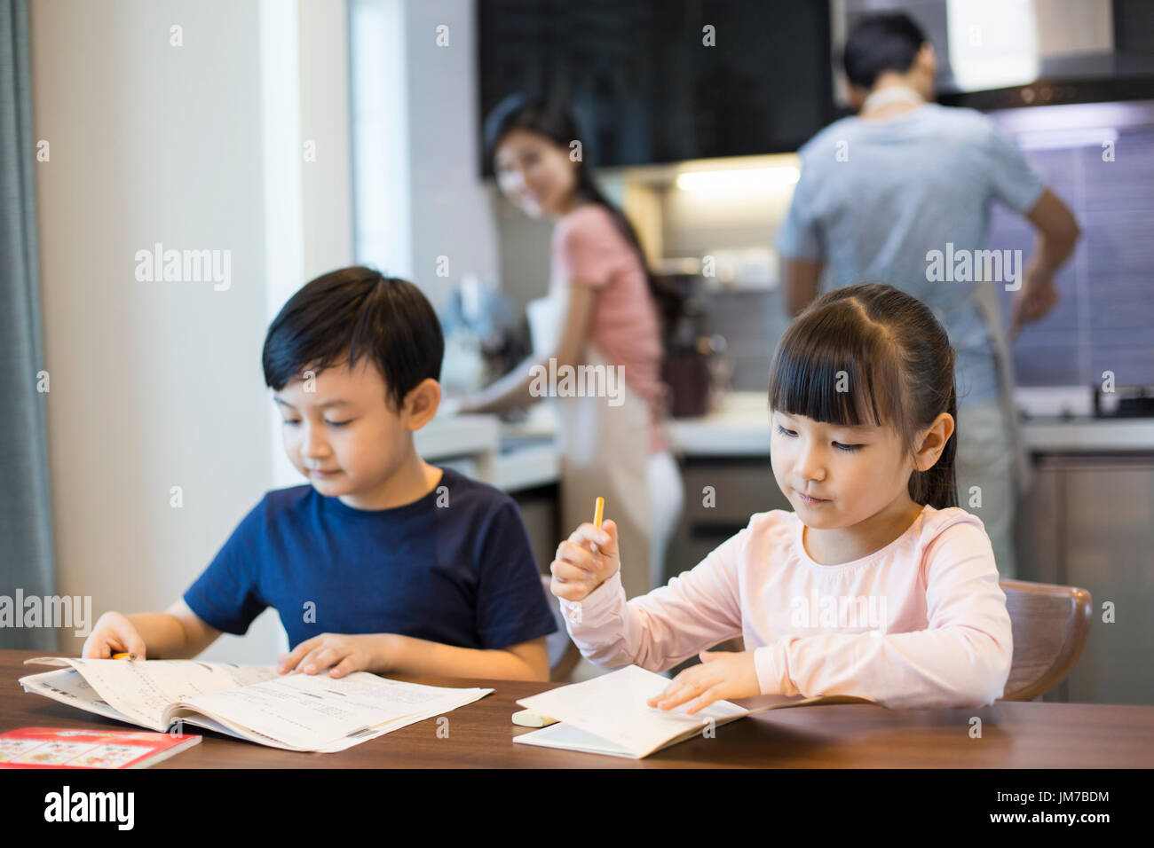Happy Chinese siblings studying together at home Stock Photo Alamy