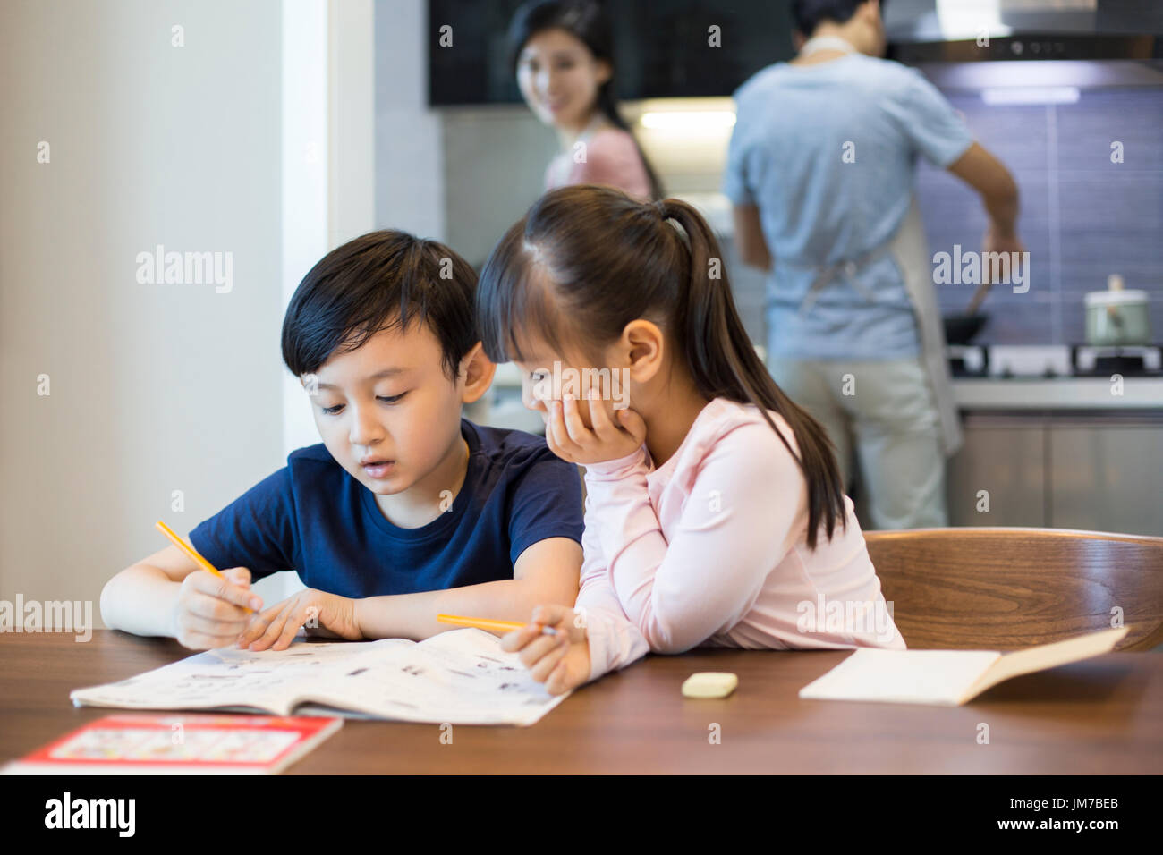 Happy Chinese siblings studying together at home Stock Photo Alamy