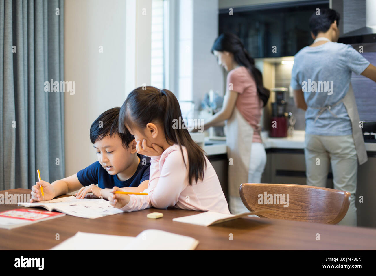 Happy Chinese siblings studying together at home Stock Photo Alamy