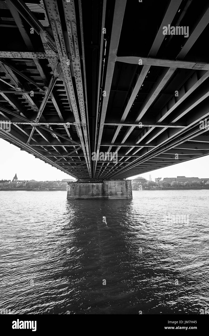 Underneath the marvelous Hohenzollern Bridge spanning the Rhine river in Cologne, Germany Stock Photo