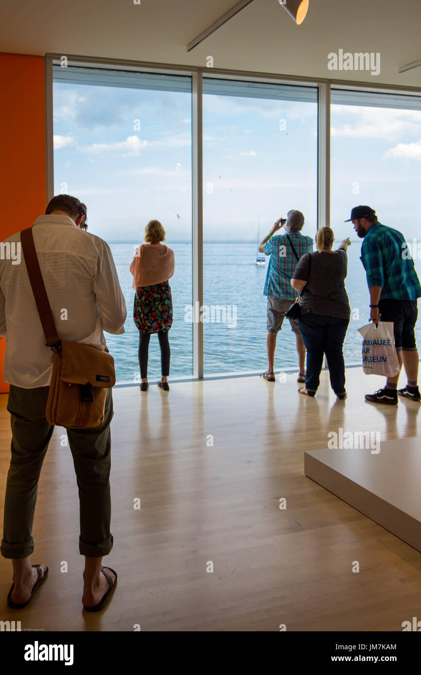 Group of people looking out the window at Lake Michigan. Stock Photo