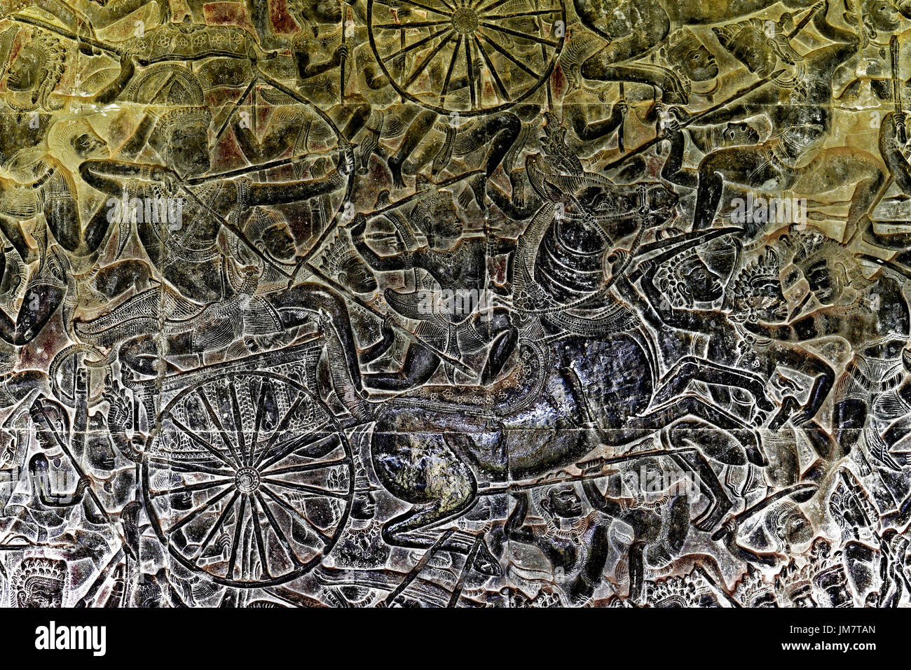 Cambodia Angkor Wat internal temple complex wall carving Khmer warriors and archers chariots and horses in battle Stock Photo