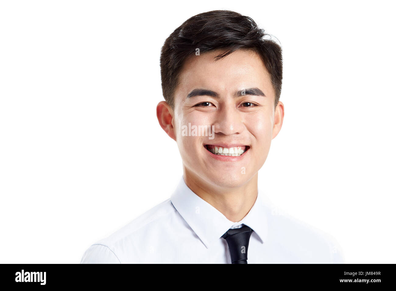 head shot of a young asian businessman, happy and smiling, studio shot, isolated on white background. Stock Photo