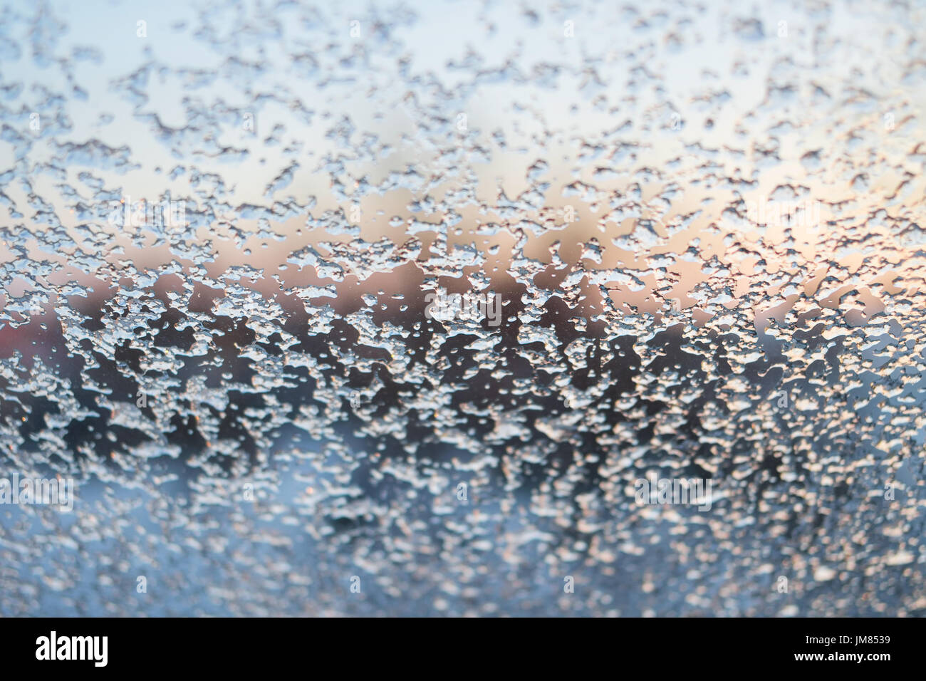 Frozen window winter background at sunrise Stock Photo