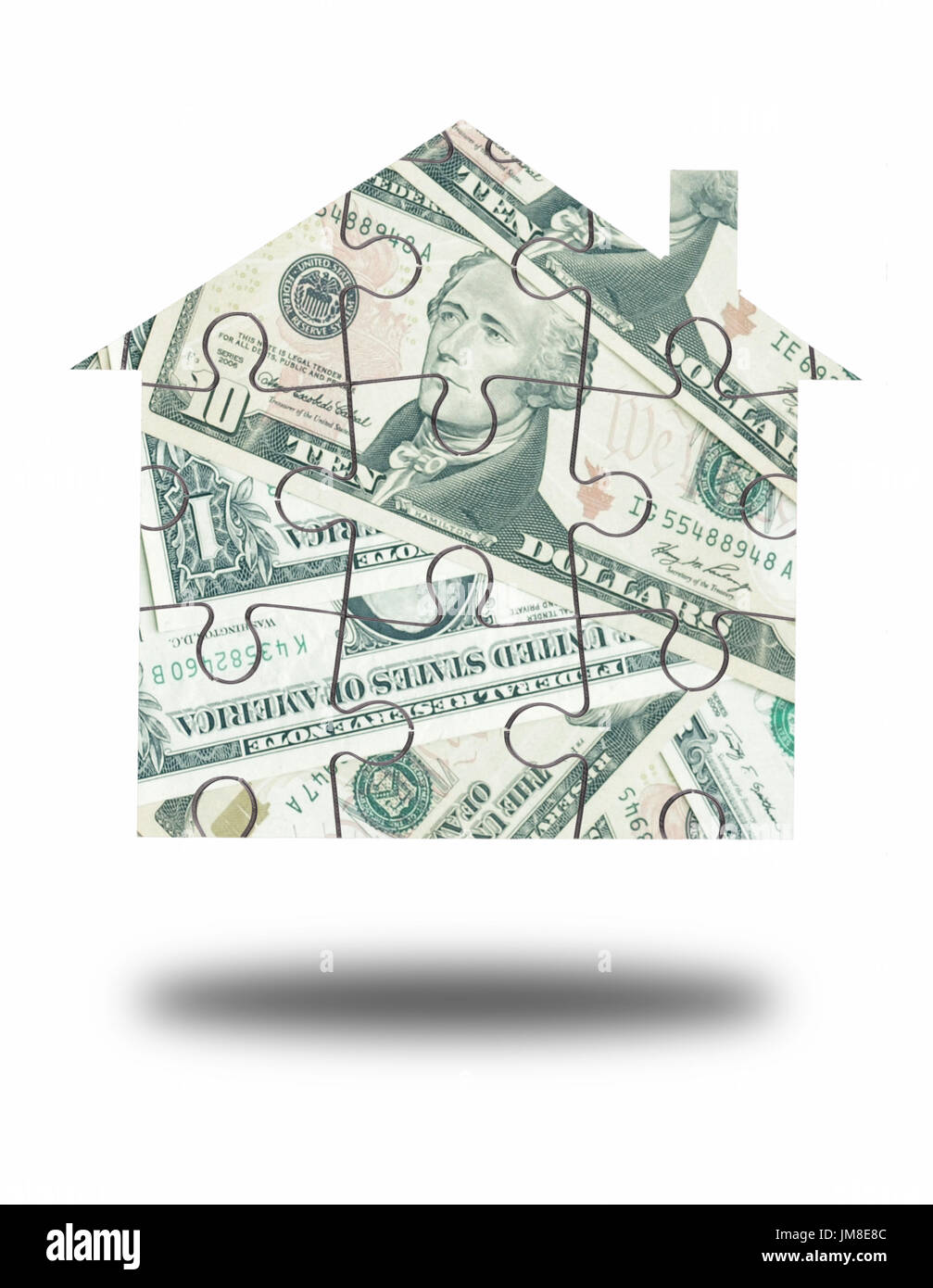 Dollar house jigsaw puzzle over a white background Stock Photo
