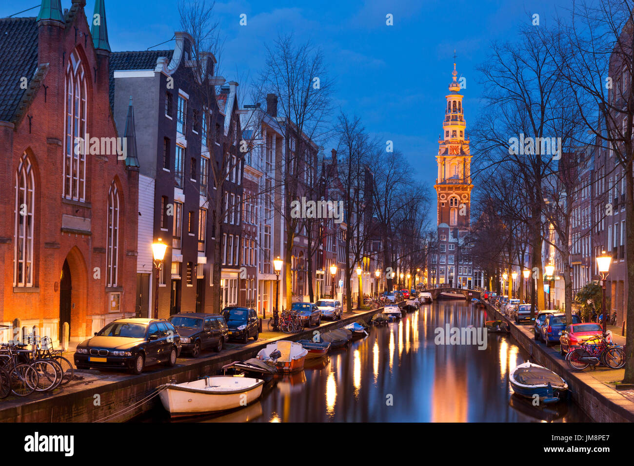 A church tower at the end of a canal in the city of Amsterdam, The Netherlands at night. Stock Photo