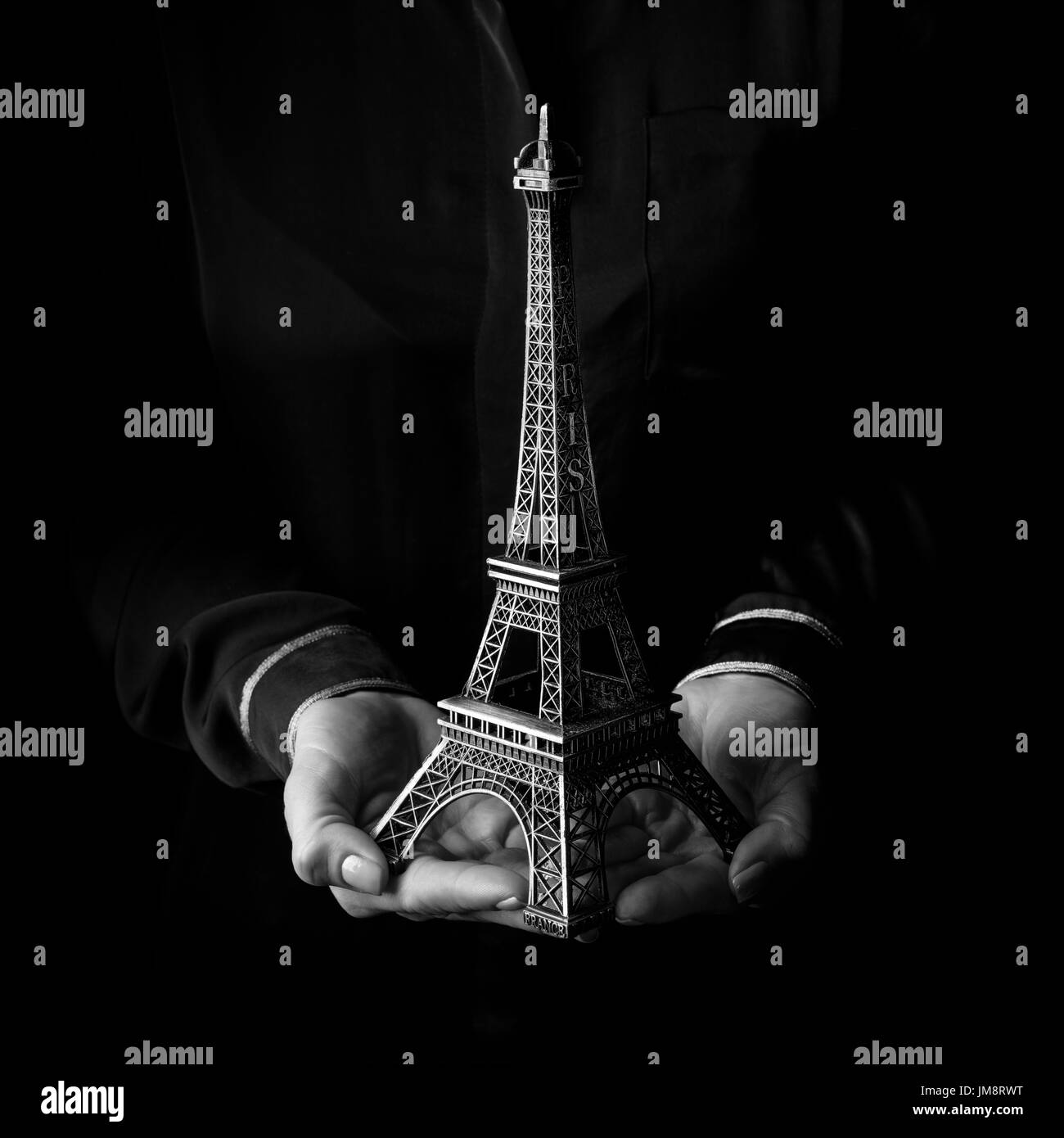 Black Mania. female hands isolated on black background showing eiffel tower Stock Photo