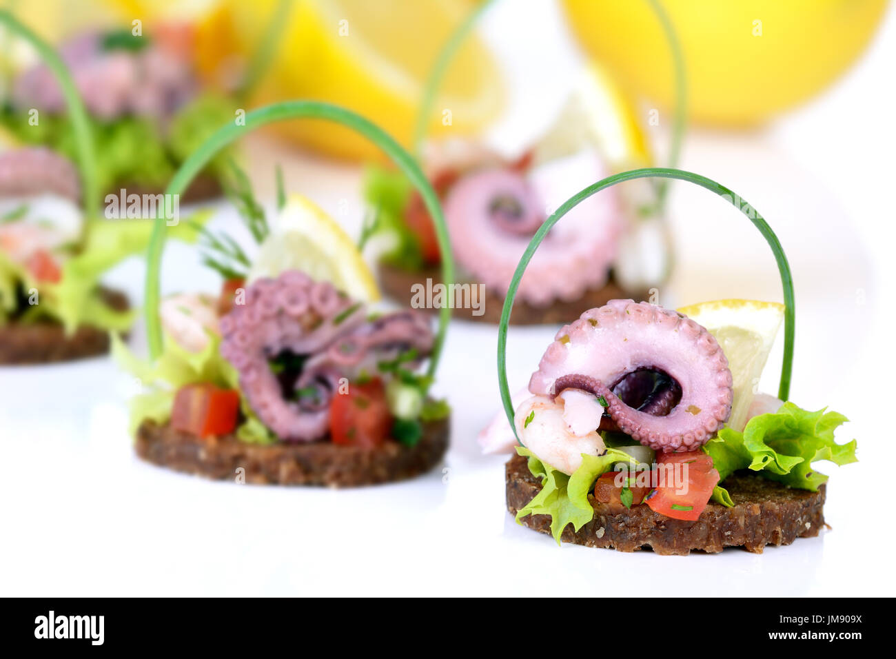 Decorative seafood salad on round slices of wholemeal bread Stock Photo