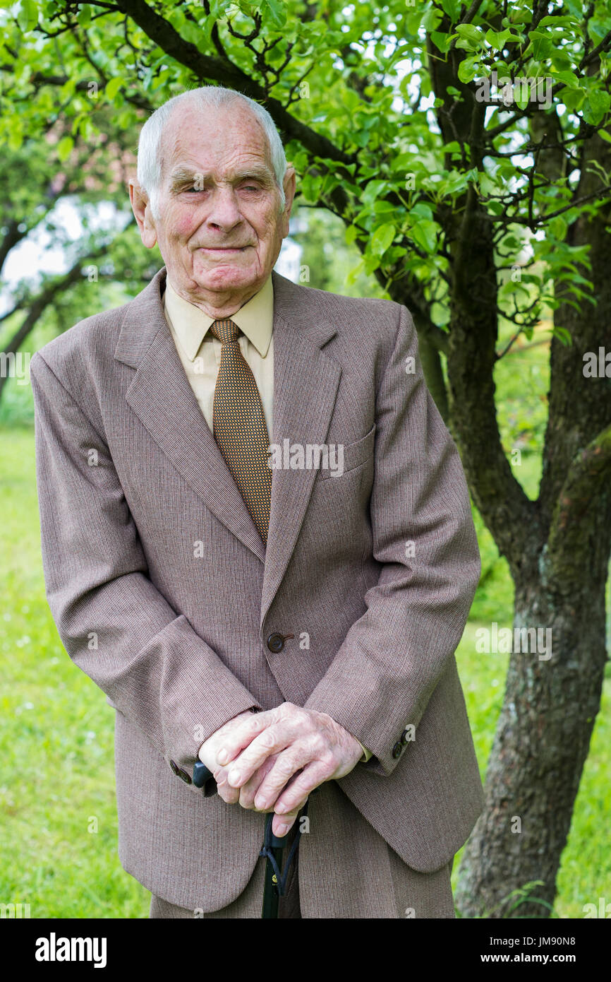 Handsome 80 plus year old senior man posing for a portrait in his