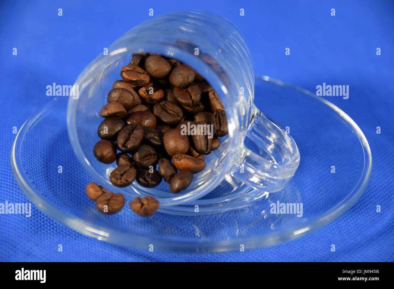 Espresso in a glass cup with coffee beans Stock Photo