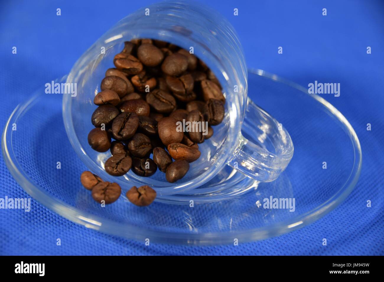 Espresso in a glass cup with coffee beans Stock Photo