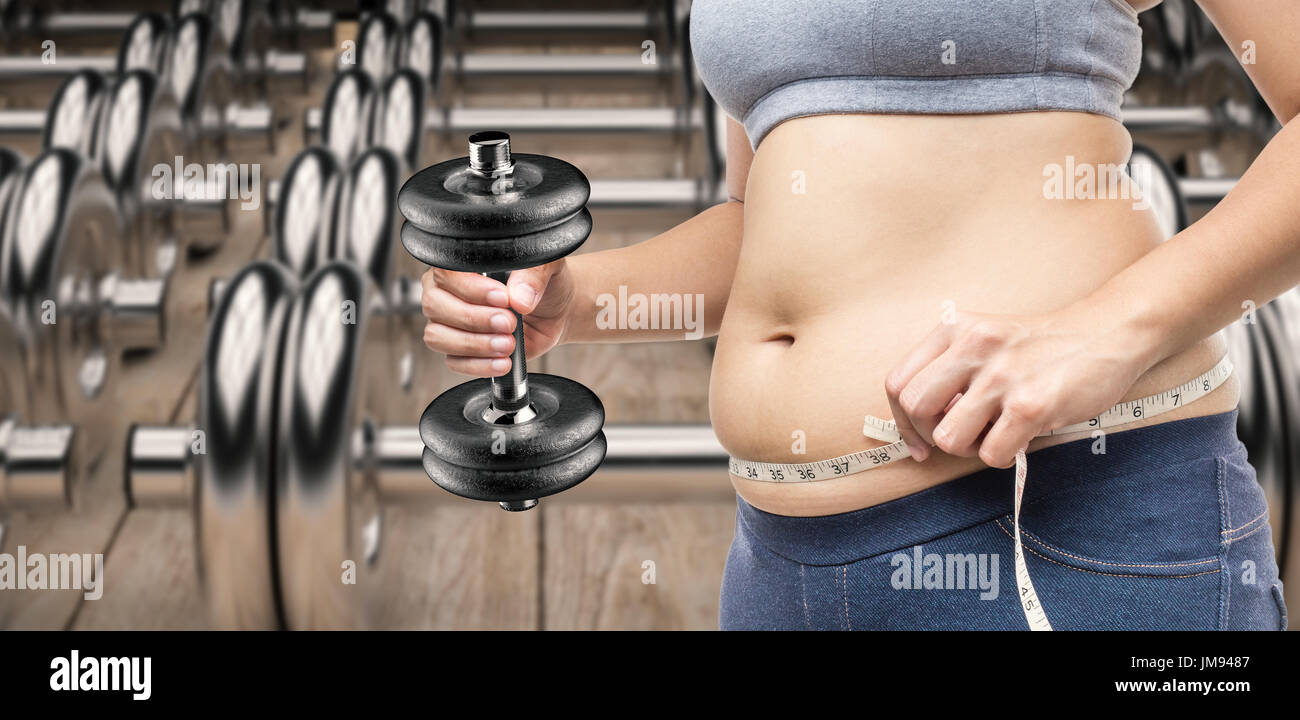 Woman plus size in gym doing exercises with barbell powerlift, female XXL  losing weight, fat model working with her body in fitness hall, healthy  lifestyle and diet Stock Photo