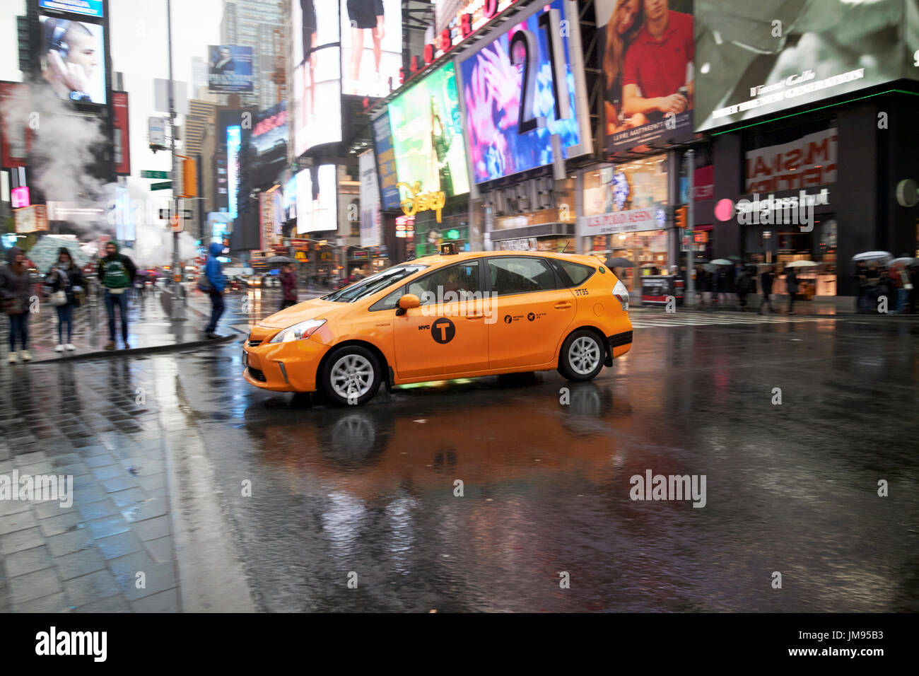 new york yellow taxi cab crossing times square in the rain New York City USA Stock Photo