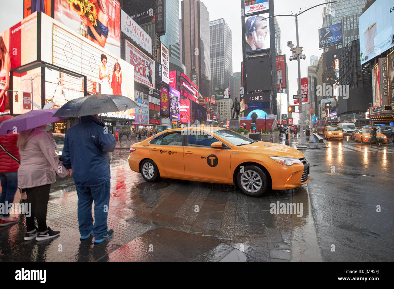 toyota camry hybrid new york yellow taxi cab crossing times square in the rain New York City USA Stock Photo