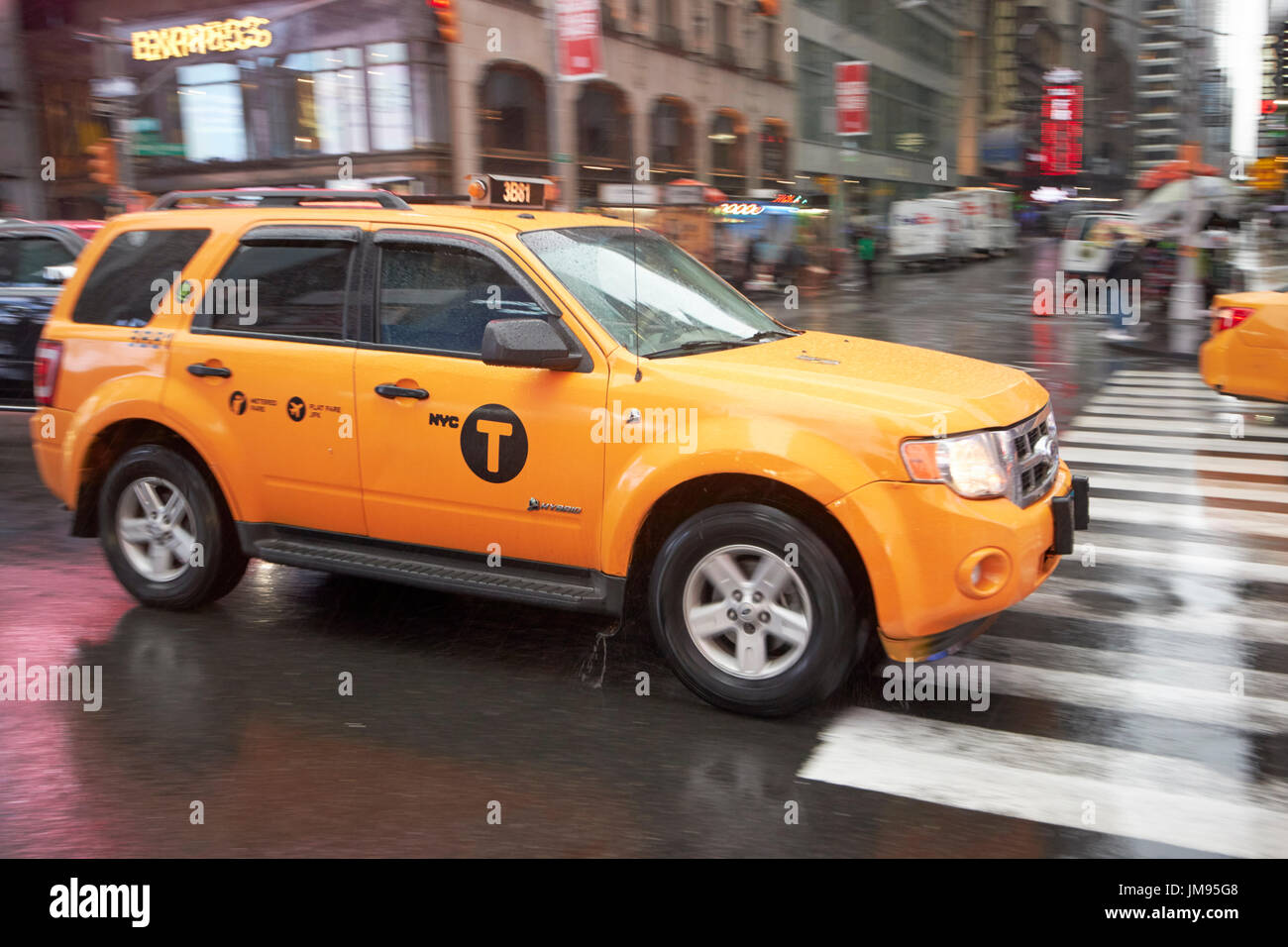 ford escape hybrid suv new york yellow taxi cab crossing times square in the rain New York City USA Stock Photo