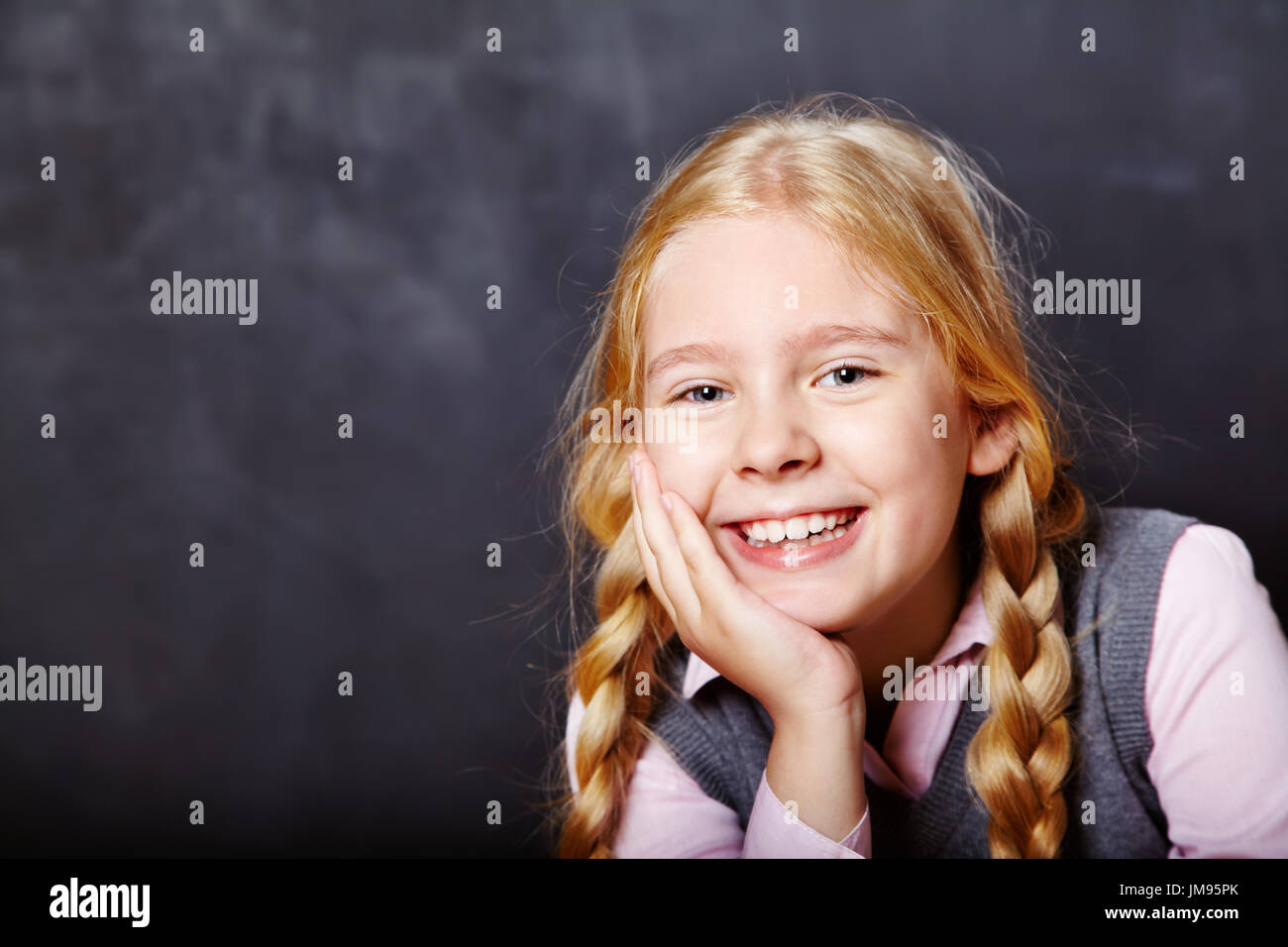 schoolchild on blackboard background Stock Photo