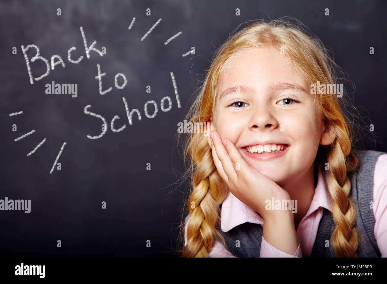 schoolchild on blackboard background Stock Photo