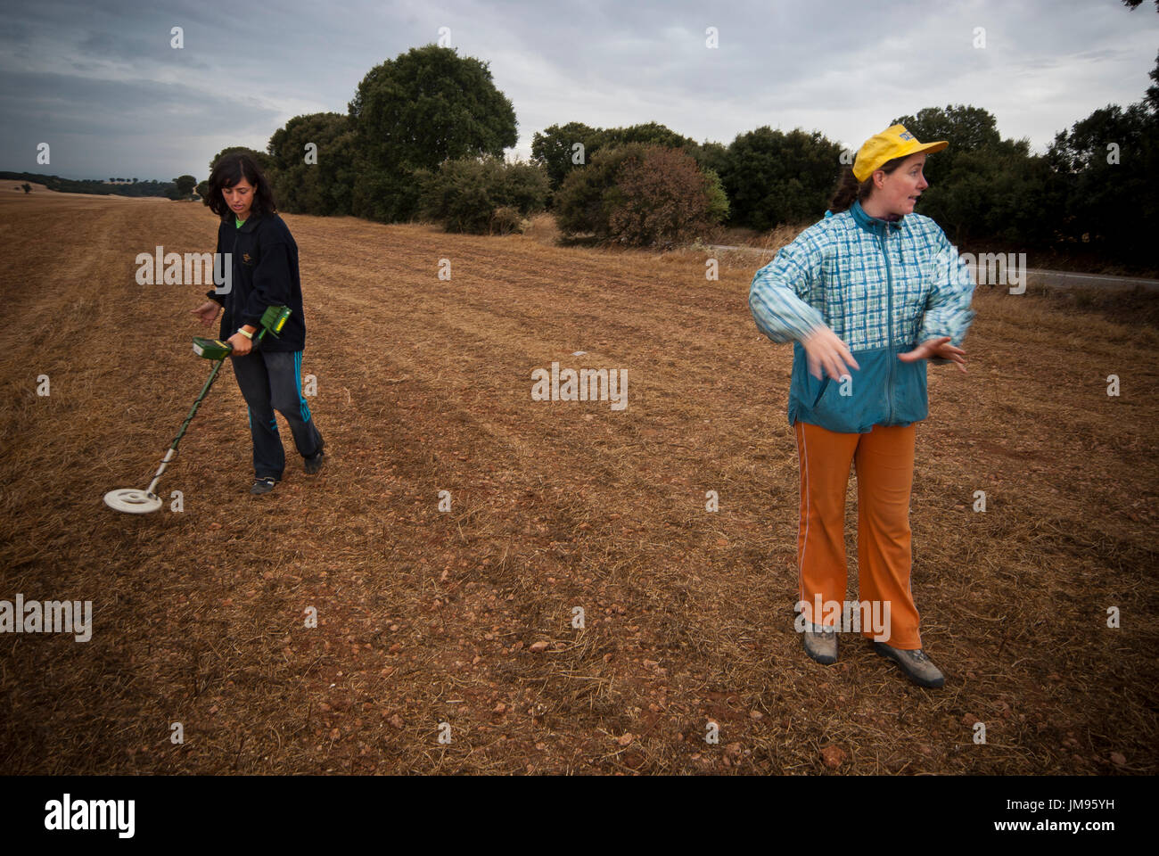 Two students who volunteer with the Association for the Historical Memory search with a metal detector a possible mass grave in La Andaya mountain, close to the village of Lerma, Burgos. Four mass graves were found with 87 bodies including the remains of seven mayors several councillors and even a provincial member of the Parliament. Stock Photo