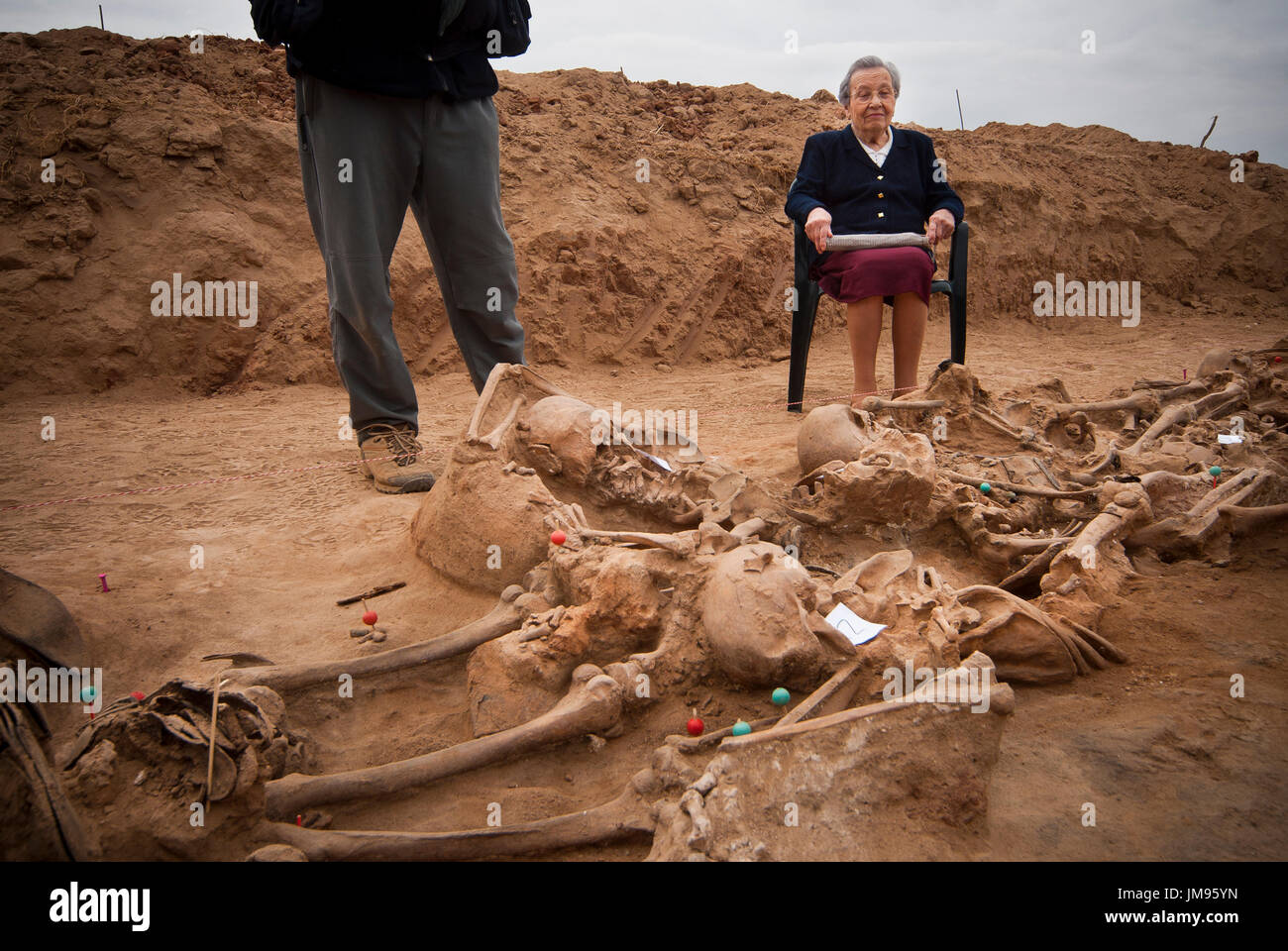 Piedad Barbadillo Anton (Lerma, b. 1922), sits by the remains of her uncle, Ampelio Anton in the mass grave that contains 22 bodies more in La Andaya mountain, close to the village of Lerma, Burgos. Four mass graves were found with 87 bodies including the remains of seven mayors several councillors and even a provincial member of the Parliament. Piedad remembers how Falangists came to the door of his uncle at 3:00 AM on August 26th 1936. Stock Photo