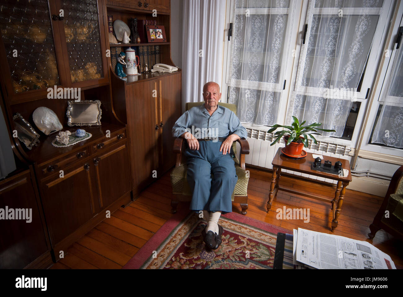 Angel Madariaga Torres (b. 1915, Bilbao - d. 2013, Bilbao), fought for the Basque Nationalist Army for the Spanish Republican Government close to the Iron Belt, Poses in his living room for an interview portrait. At the start of the war, Angel was studying. Militant of the PNV (Basque Nationalist Party), he enrolled in the nationalist militia with some friends. After some training as a communications officer, he was destination in Amorebieta. This basque village would proove as a key point for the uprised military to attack the Iron Belt and conquere Bilbao. Stock Photo