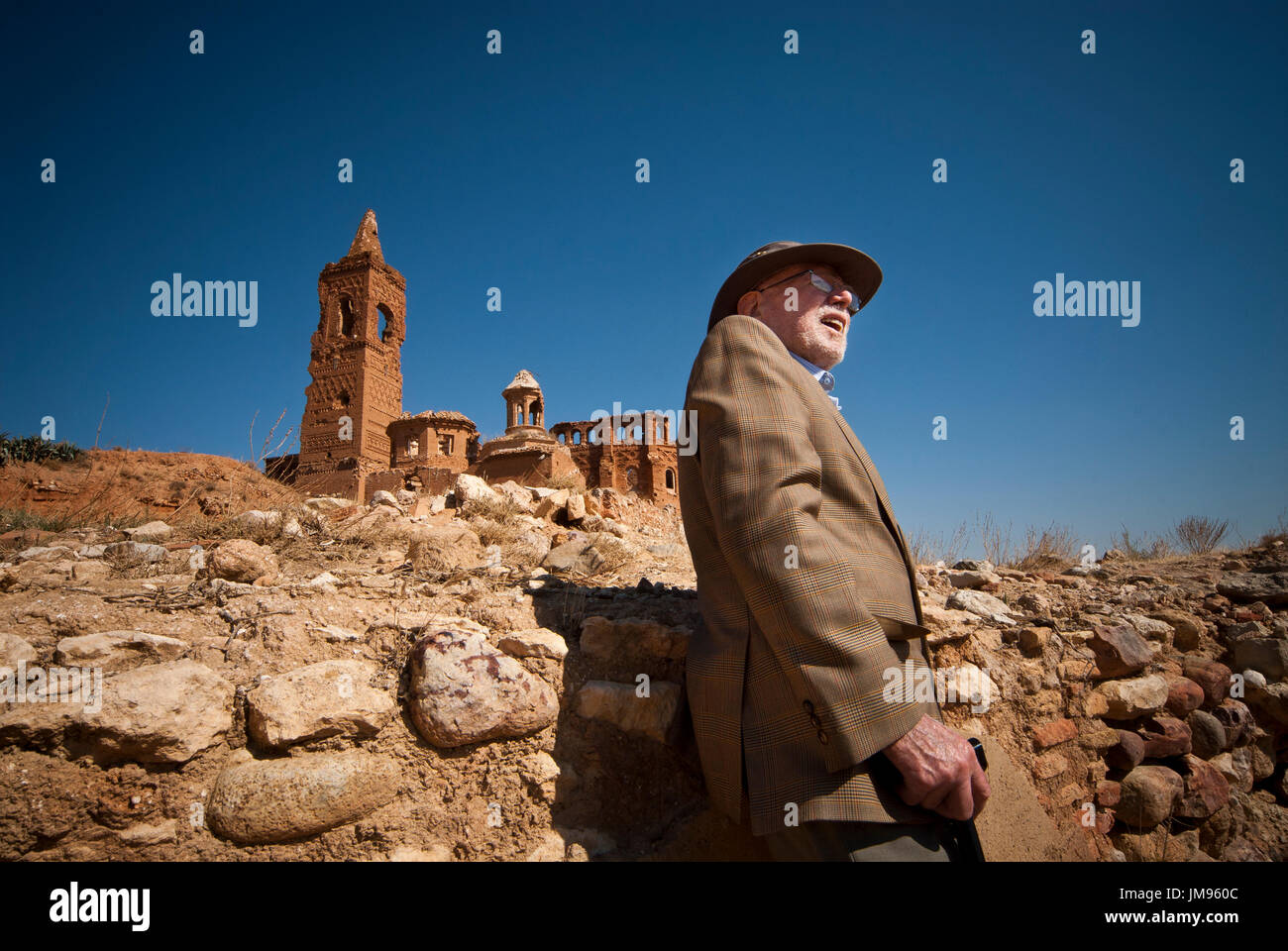 Patrick (Paddy) Cochrane (b. 1913, Dublin - d. 2012, Dublin), Irish International Brigadier that fought for the Republican Government in Belchite, poses close to the Church of Saint Martin in Belchite. Willing to fight against the Fascists in Spain, Paddy enlisted in the communist party to drive some ambulances to Spain. During a few months he drove the ambulance, but soon he changed it for a lorry because he thought it would be more useful. After some time moving between one front and the other, he is sent to Belchite. Stock Photo