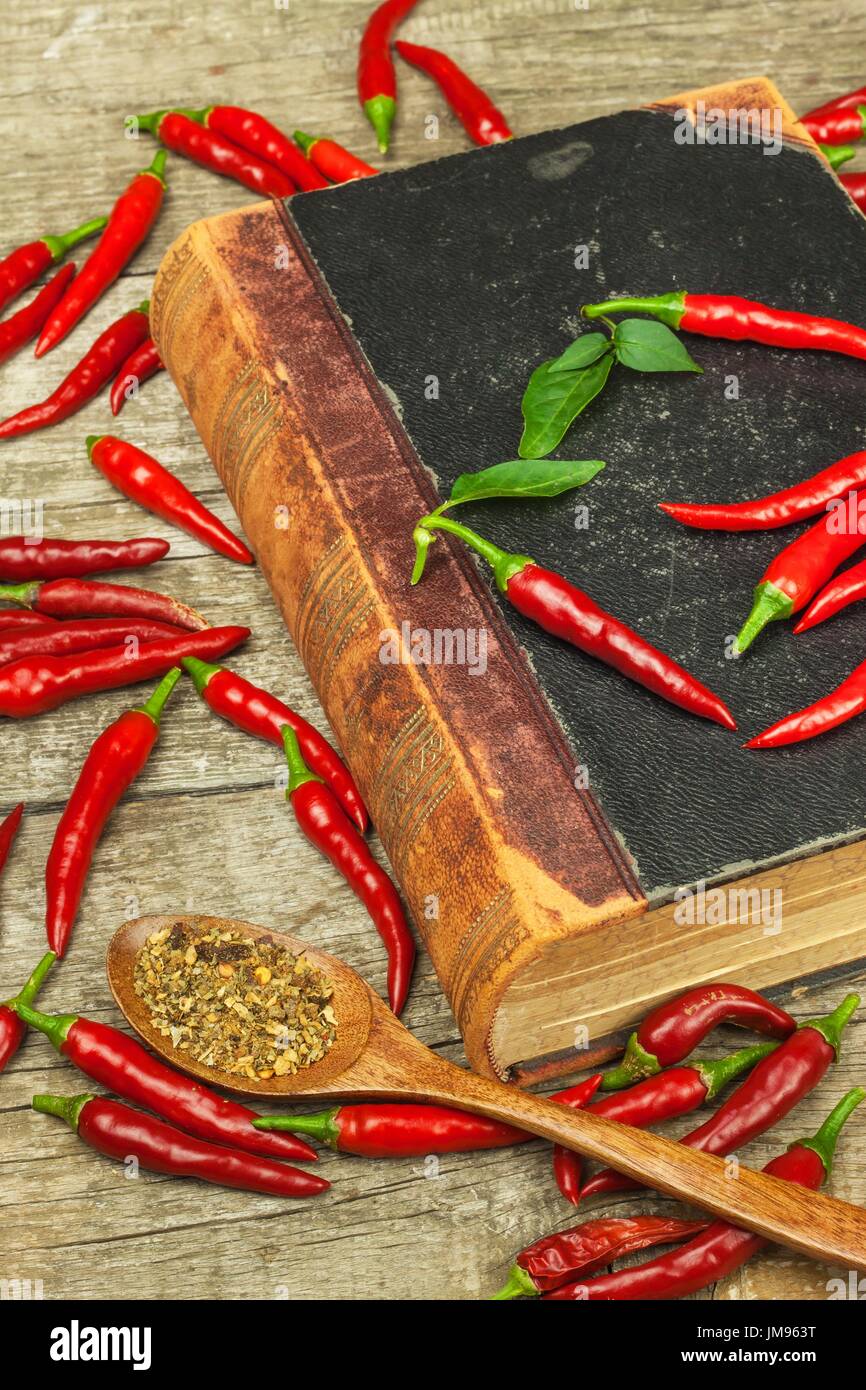 Book of old cookery recipes and fresh chili peppers. Spicy cuisine. Mexican food Stock Photo