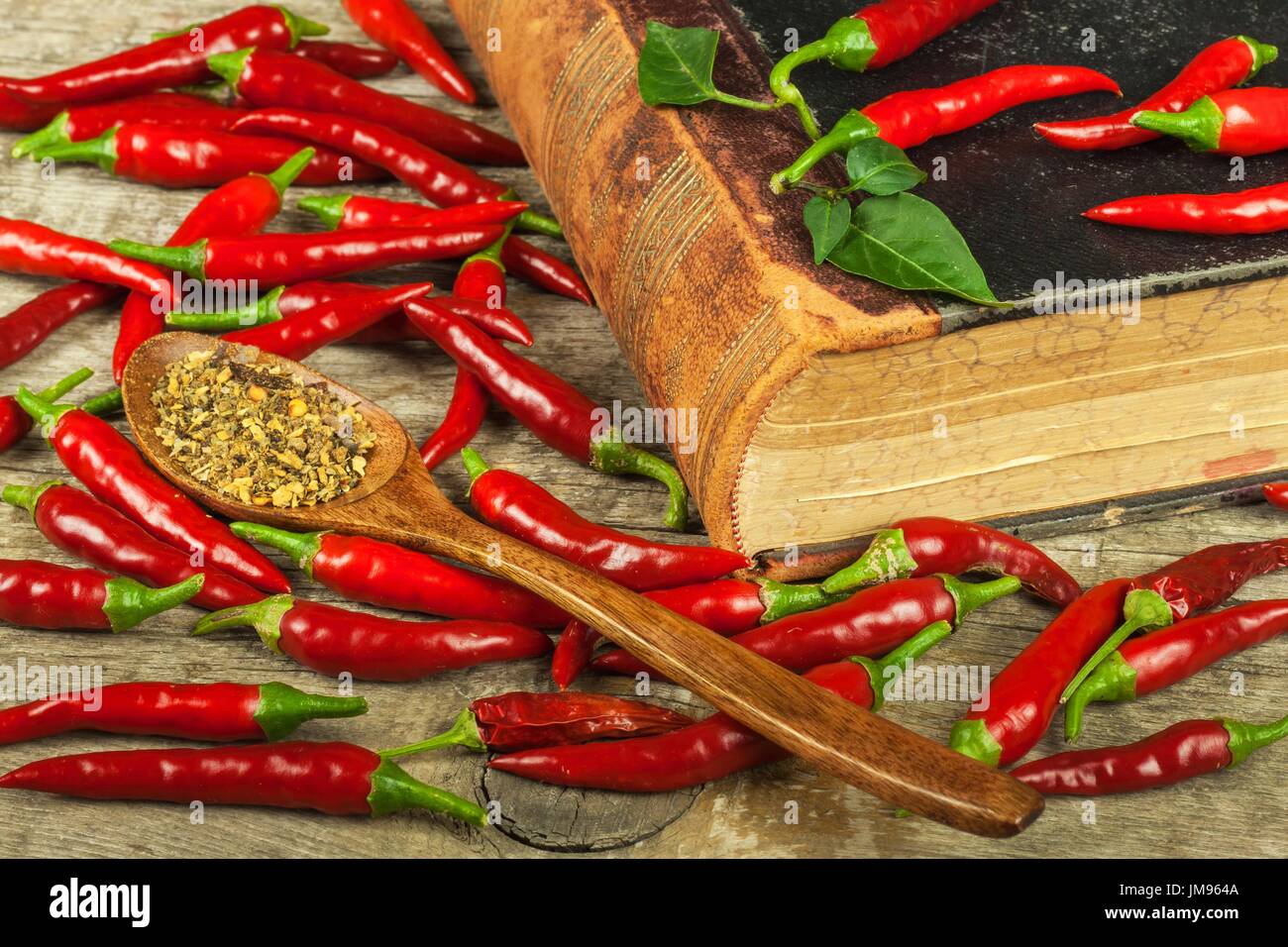 Book of old cookery recipes and fresh chili peppers. Spicy cuisine. Mexican food Stock Photo