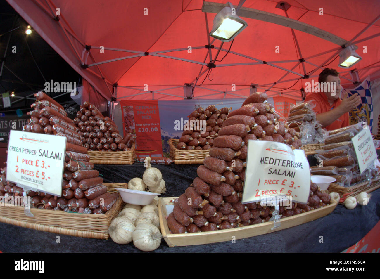Merchant city festival stallholder vendor seller of salami and sausage Glasgow Christmas market Stock Photo