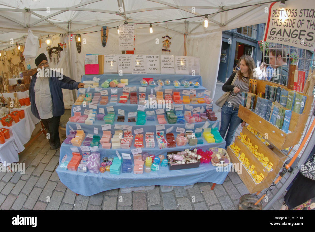 Merchant city festival stallholder vendor seller of Indian joss sticks and soap lush Glasgow Christmas market Stock Photo