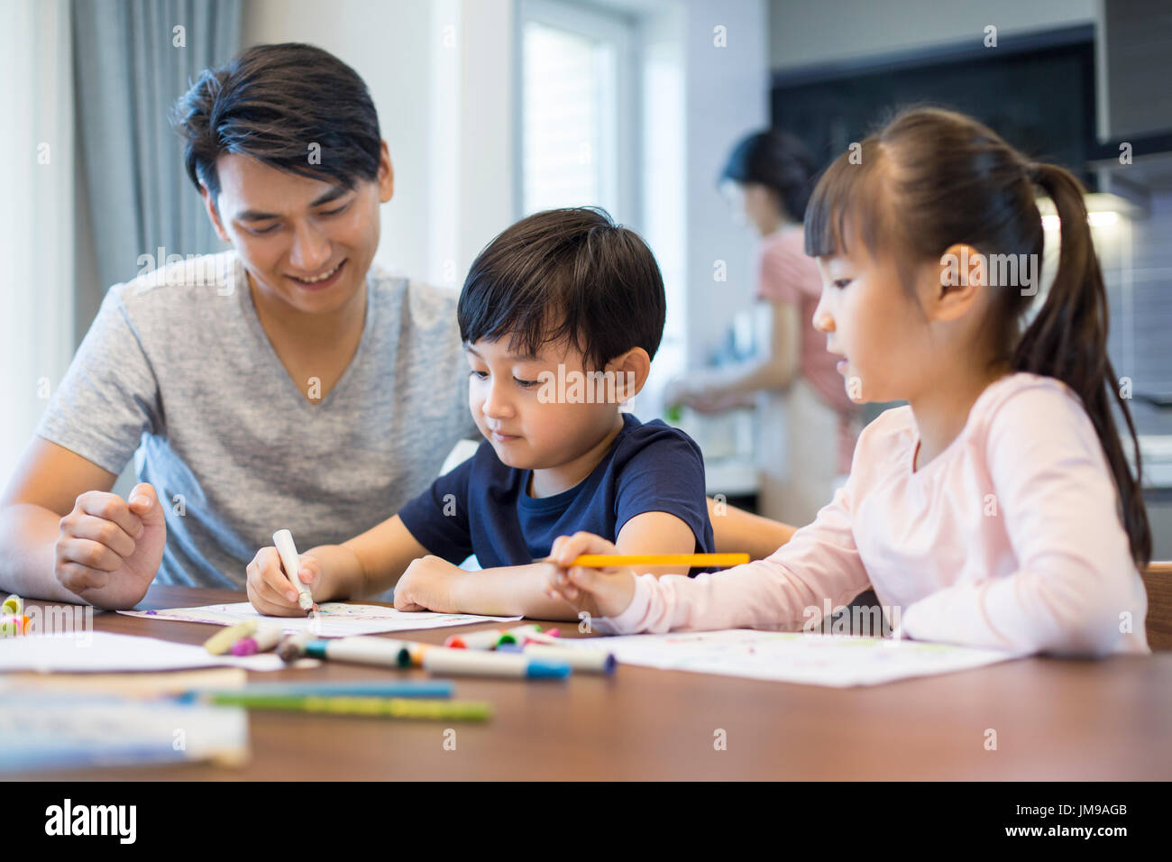 Happy Chinese siblings studying together at home Stock Photo Alamy