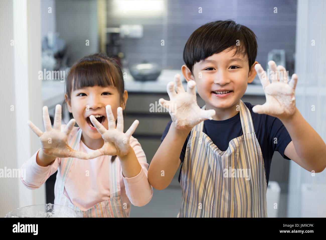 Happy Chinese siblings playing with flour Stock Photo Alamy