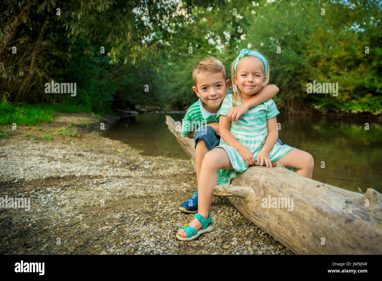 Adorable siblings posing for a portrait, summer outdoors concept Stock ...